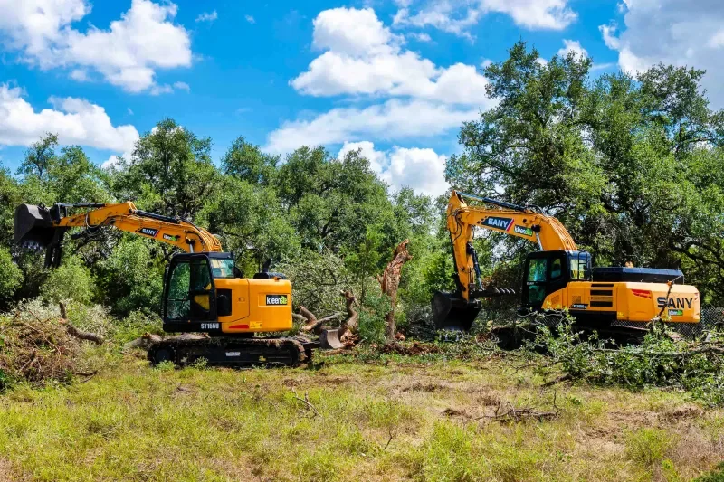 Forestry mulcher clearing brush and small trees on a job site